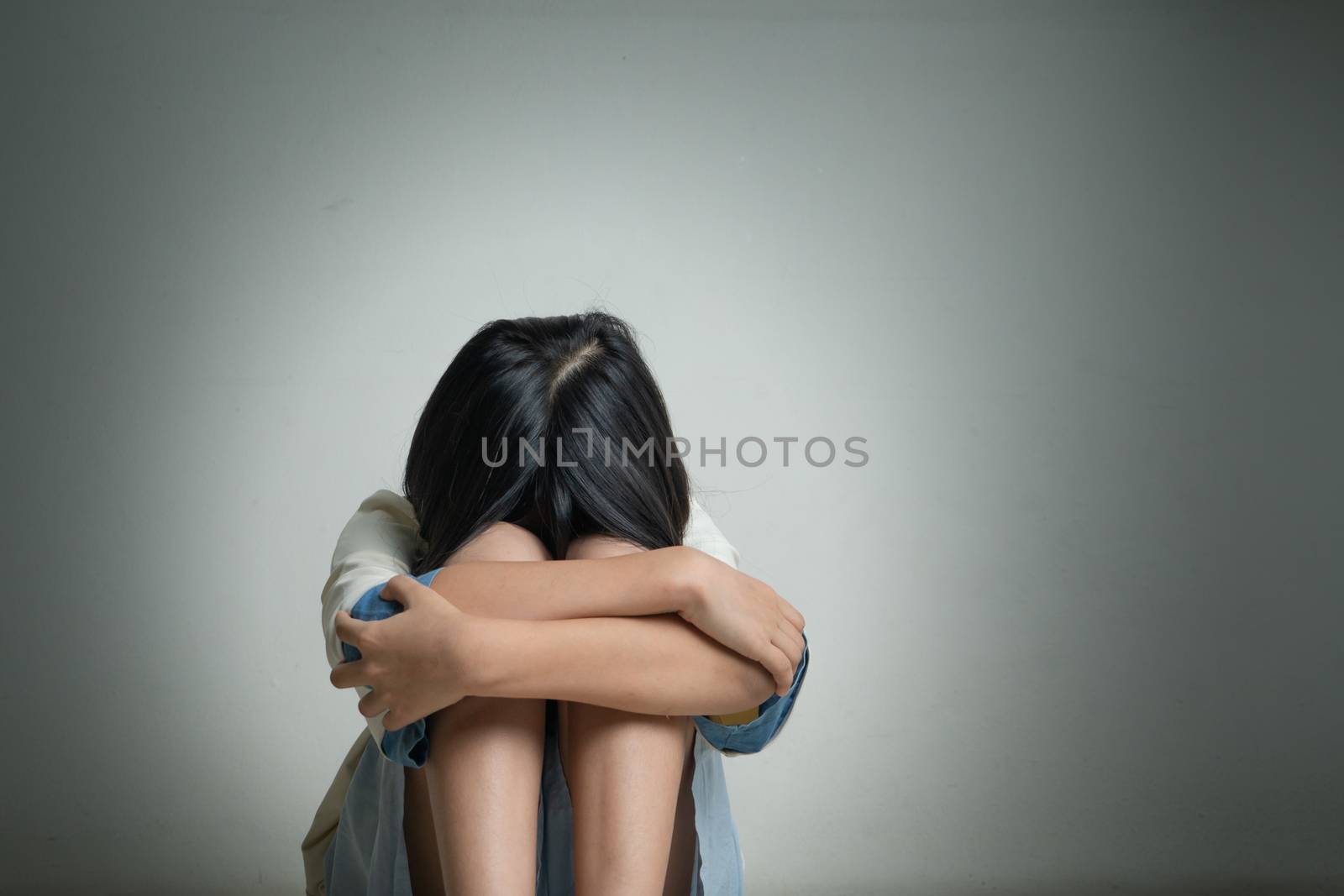 Alone and scared, sad depressed children crying in the dark room after being bullied