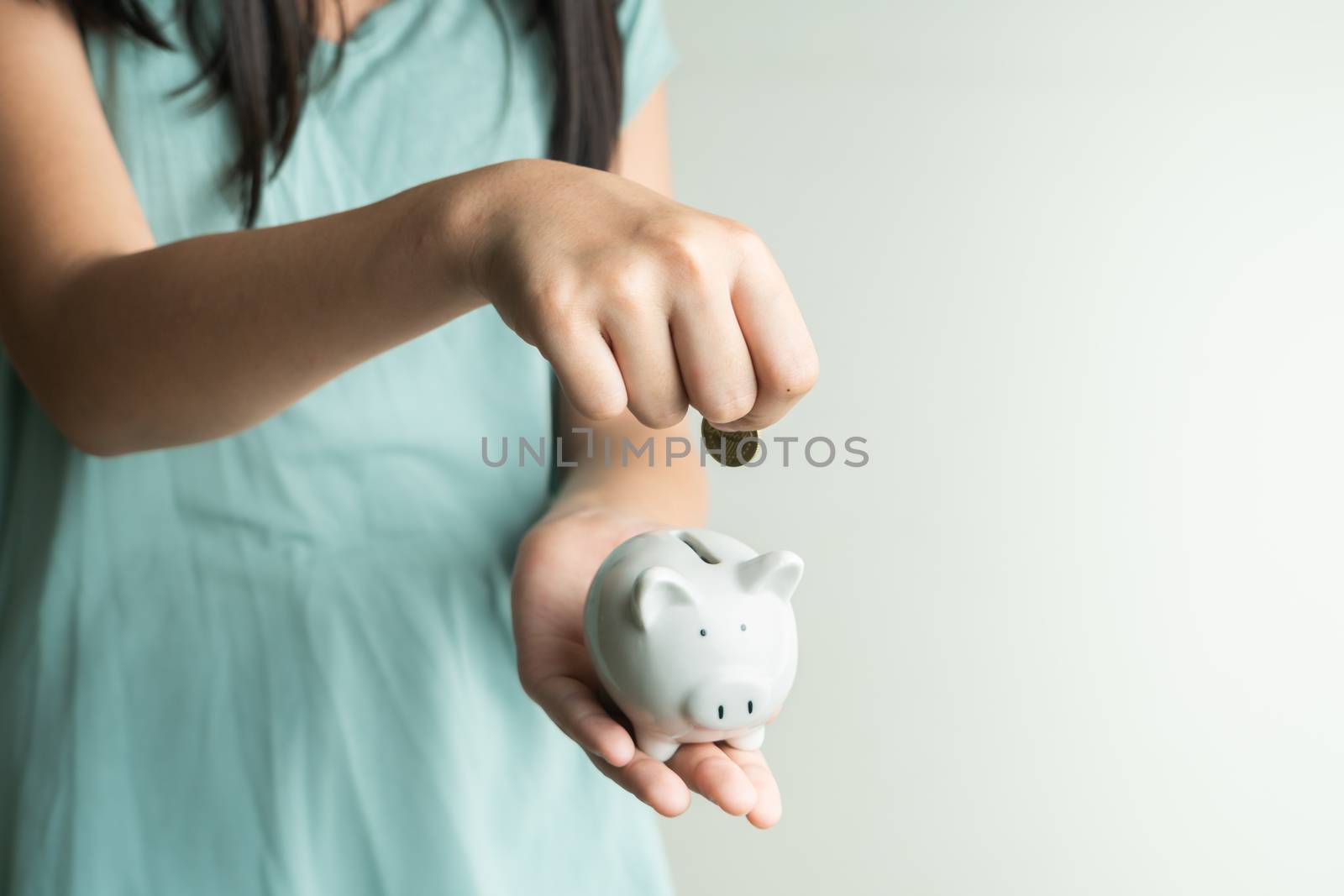 Saving and business concept, Cute girl with piggy bank and coins at home