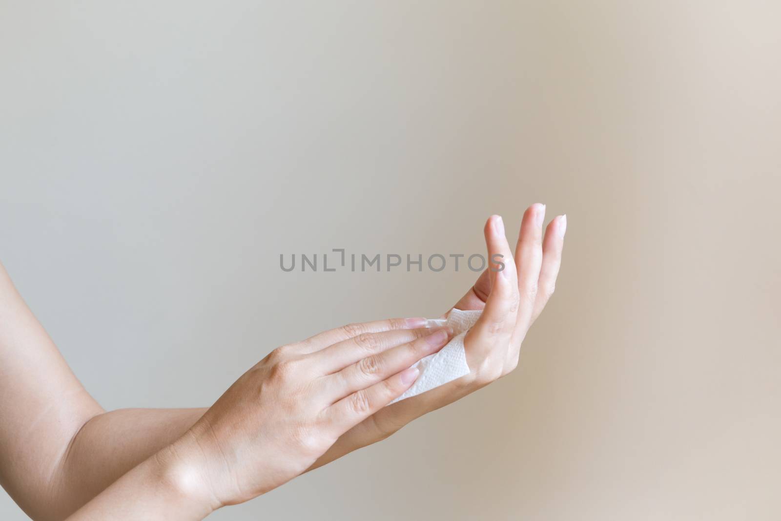 Woman cleaning her hands with white soft tissue paper. isolated on a white backgrounds