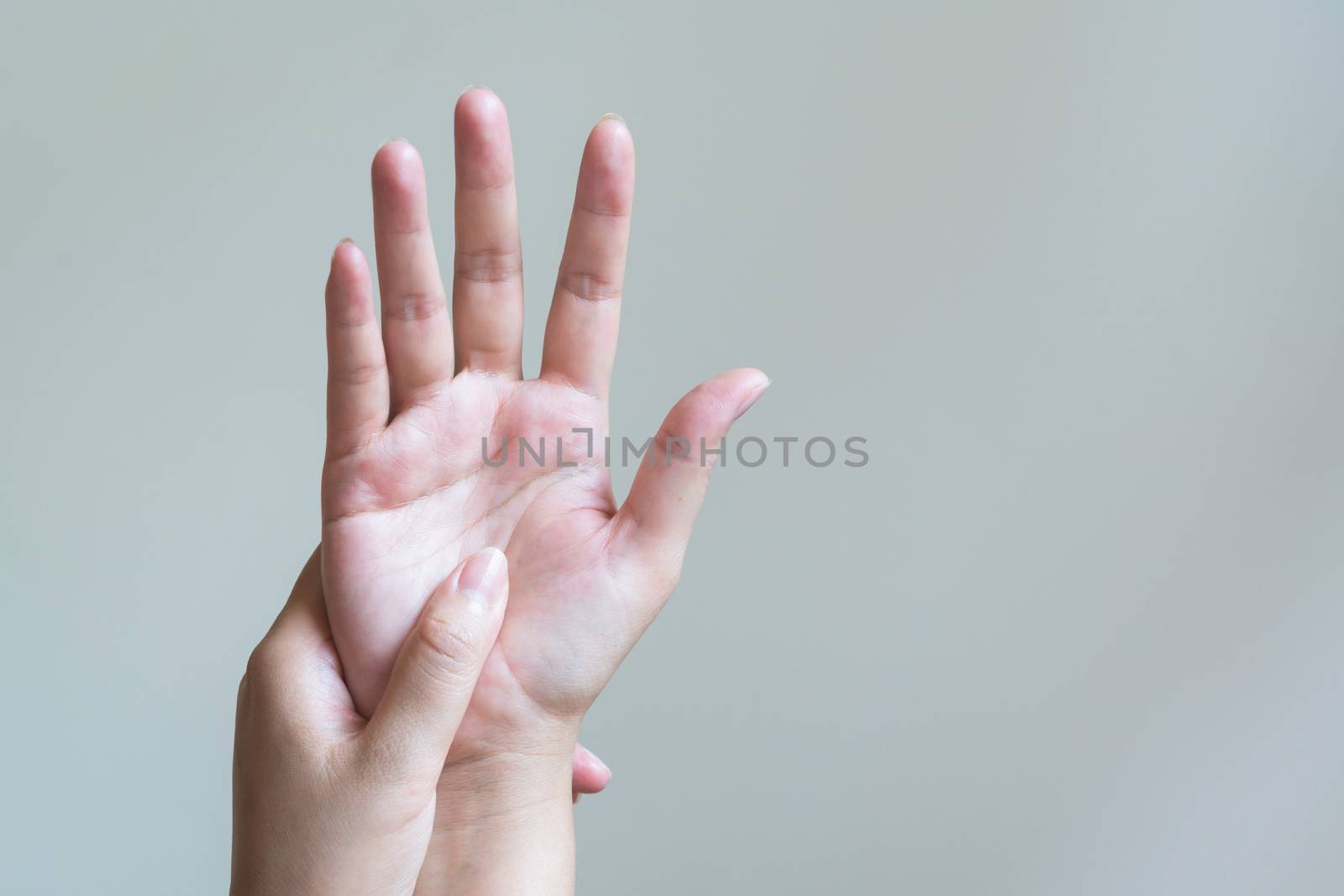 Woman massaging her painful hand. Healthcare and medical concept.