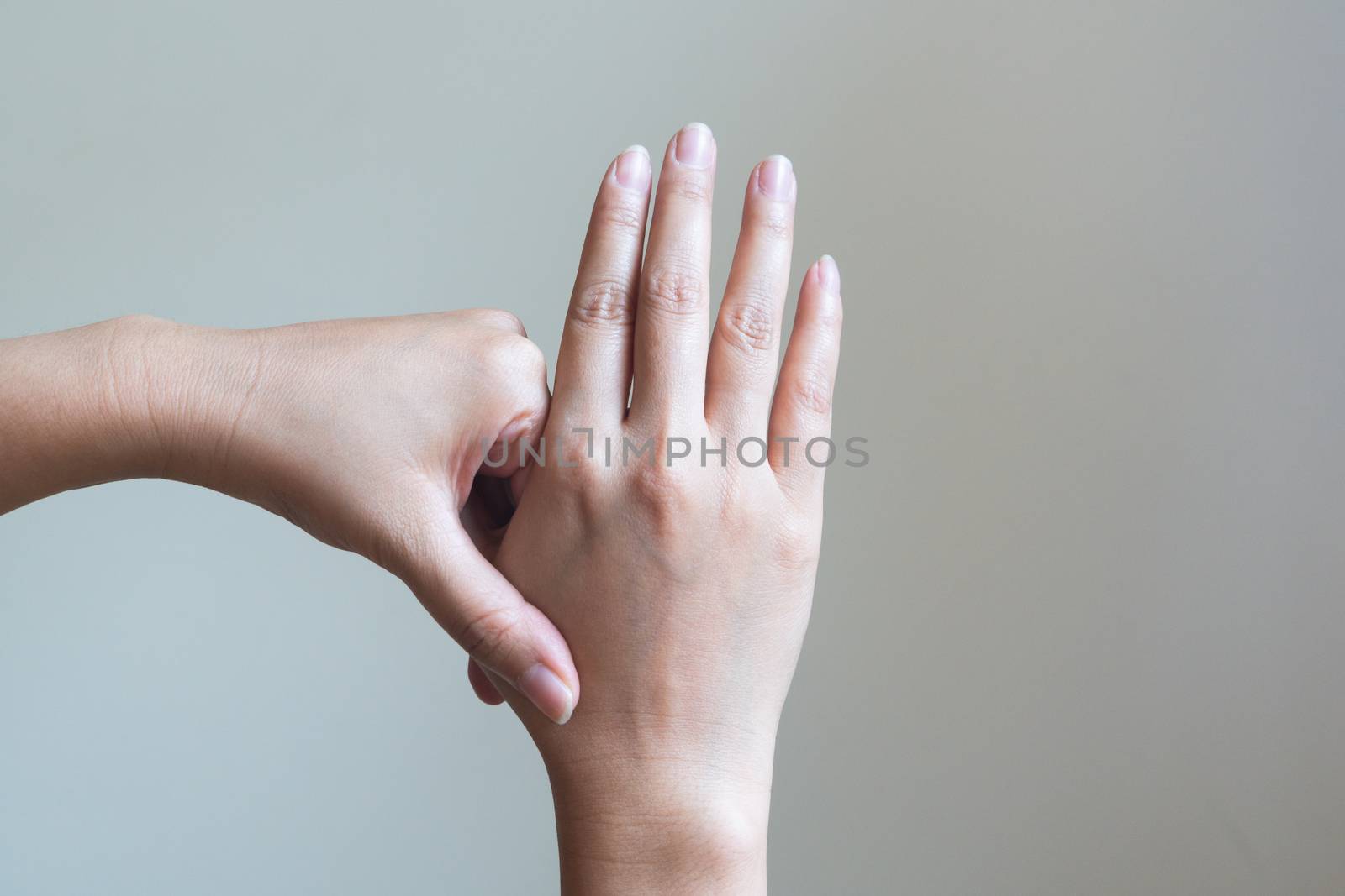 Woman massaging her painful hand. Healthcare and medical concept.