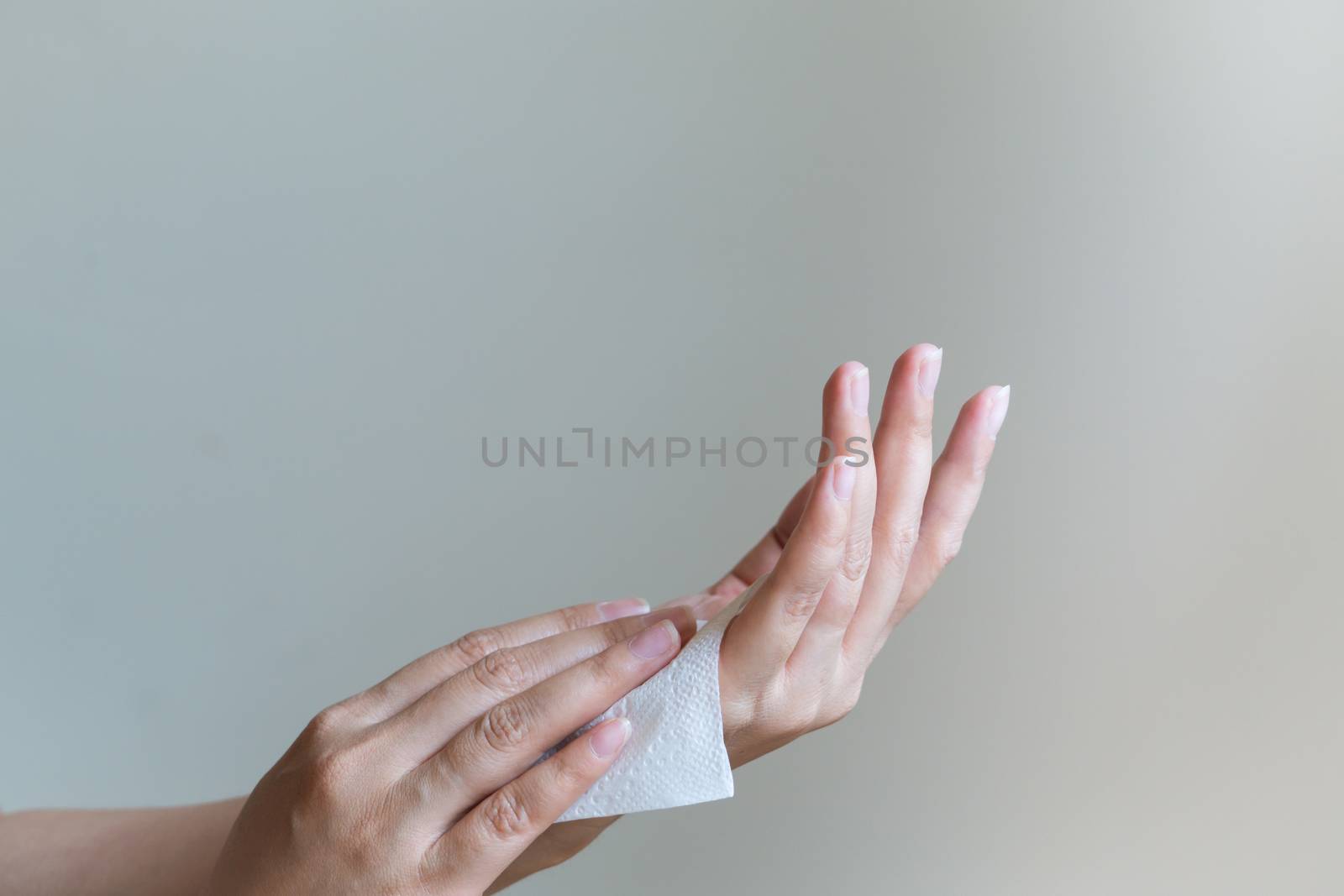 Woman cleaning her hands with white soft tissue paper. isolated  by psodaz