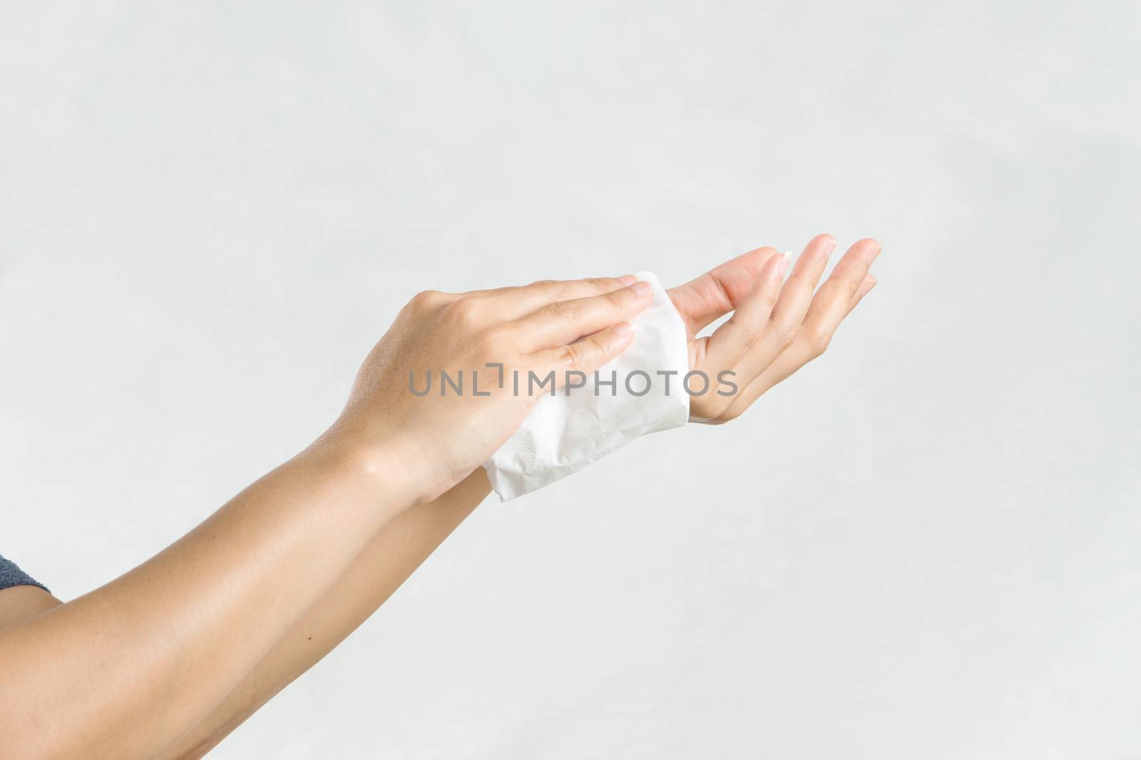 Woman cleaning her hands with white soft tissue paper. isolated on a white backgrounds