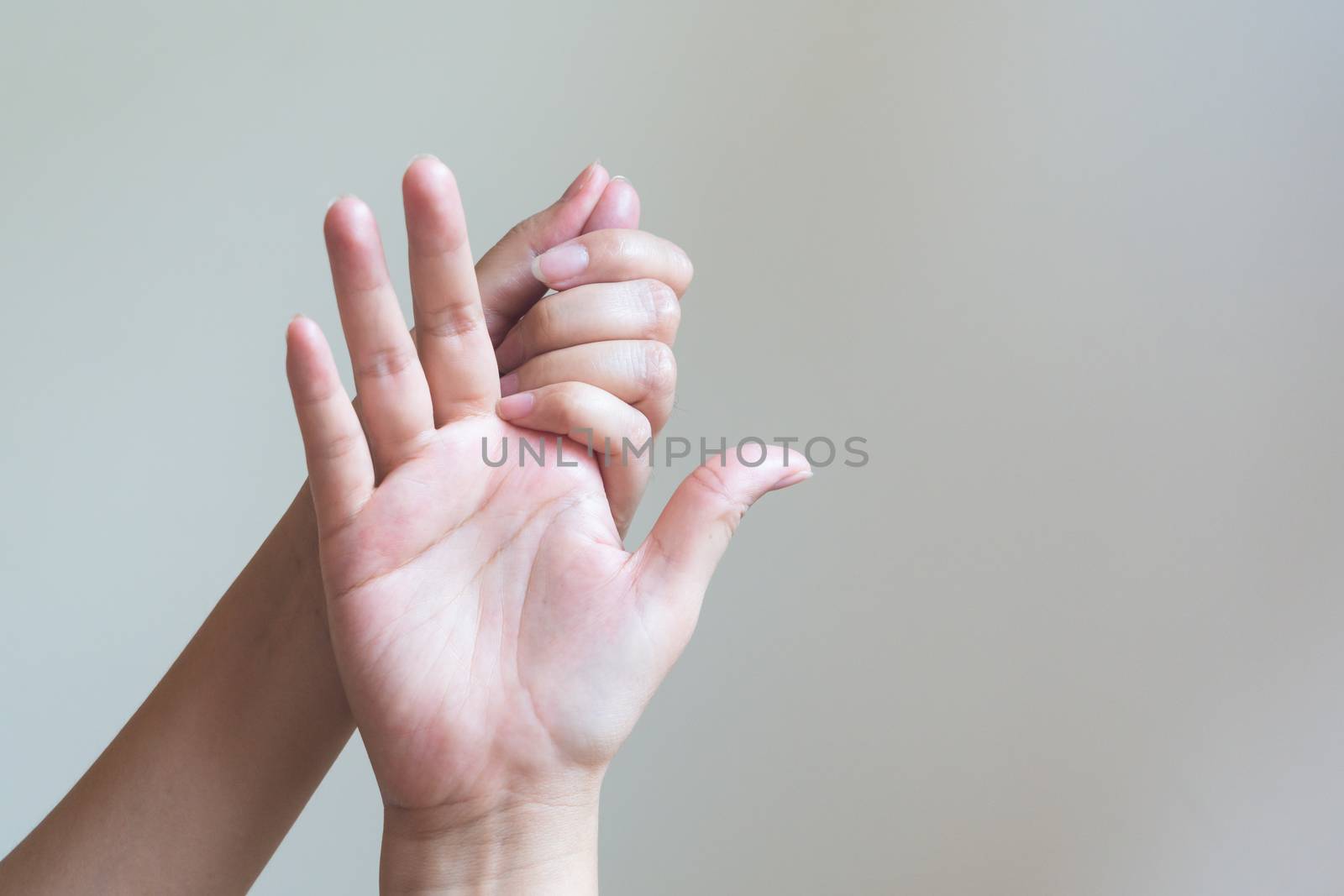 Woman massaging her painful hand. Healthcare and medical concept.