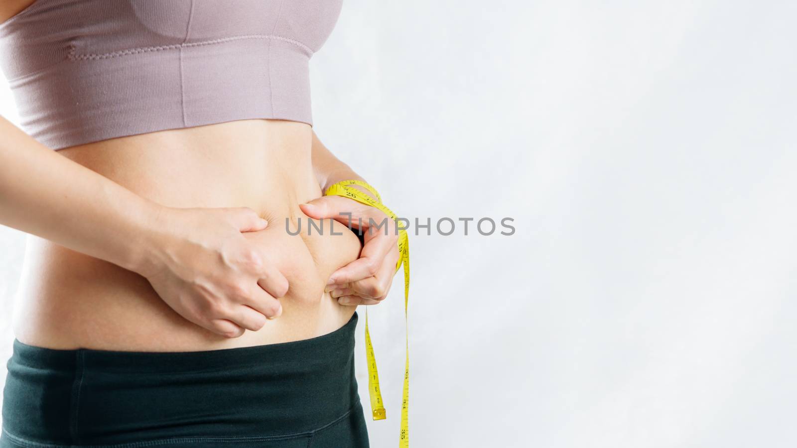 fat woman, fat belly, chubby, obese woman hand holding excessive belly fat with measure tape, woman diet lifestyle concept