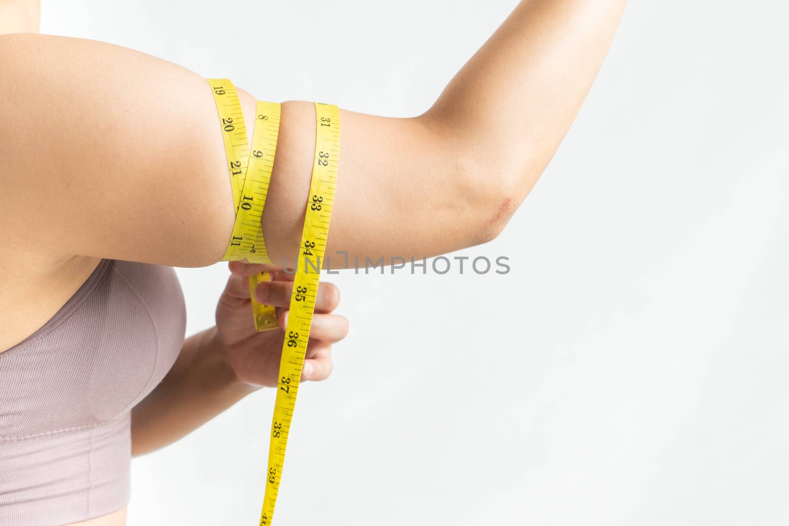 Woman show and squeeze tighten, arm body fat by measure tape, woman diet lifestyle concept