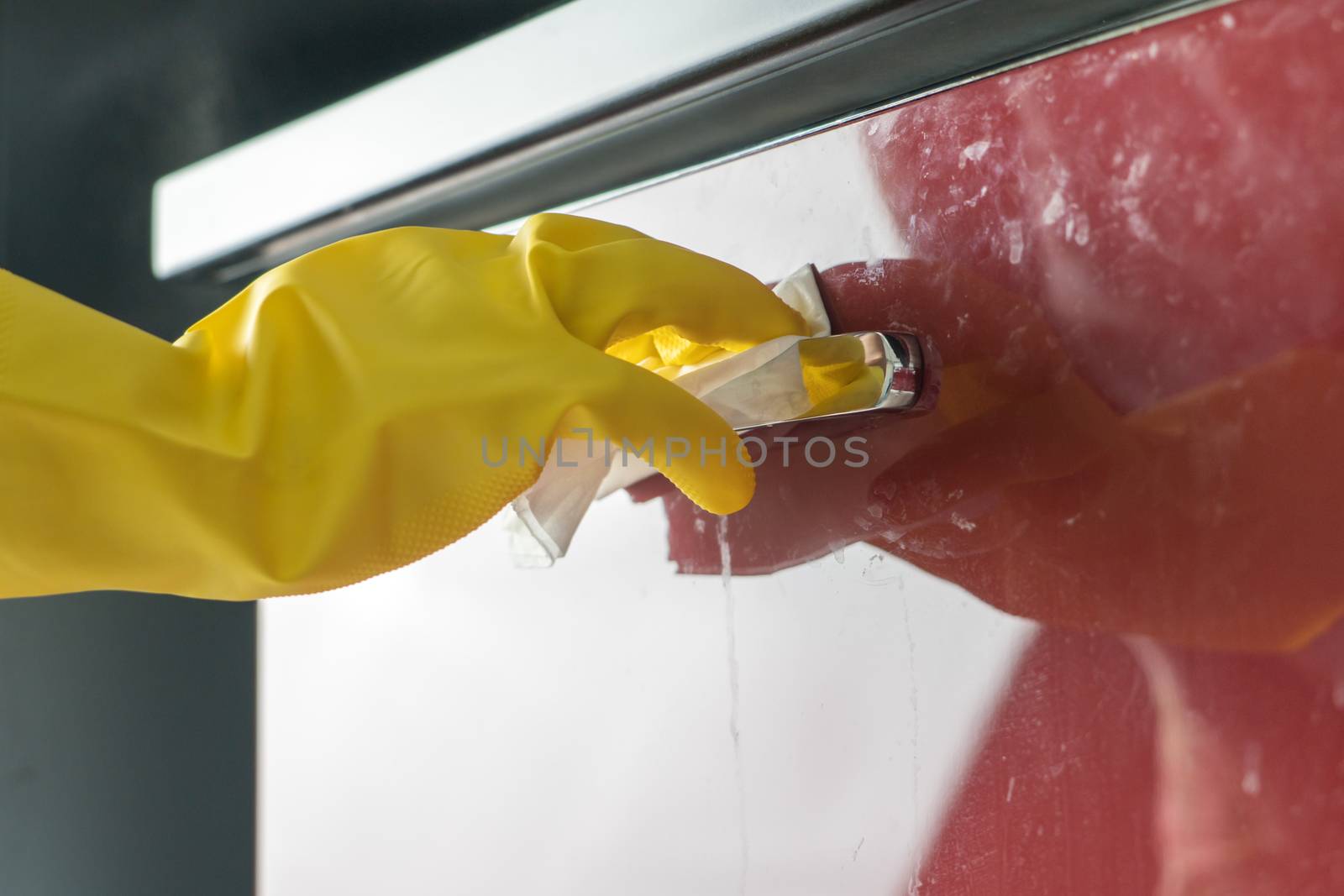 Cleaning door handle with alcohol spray for Covid-19 Coronavirus by psodaz