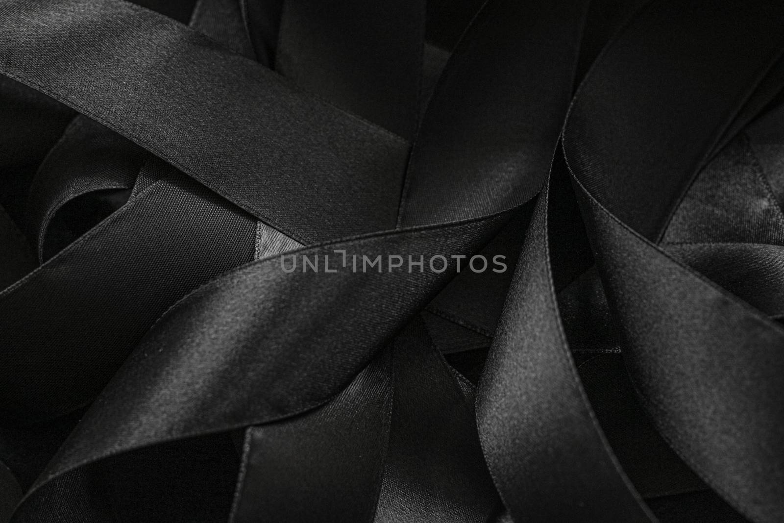 Black silk ribbon as background, abstract and luxury brand design by Anneleven