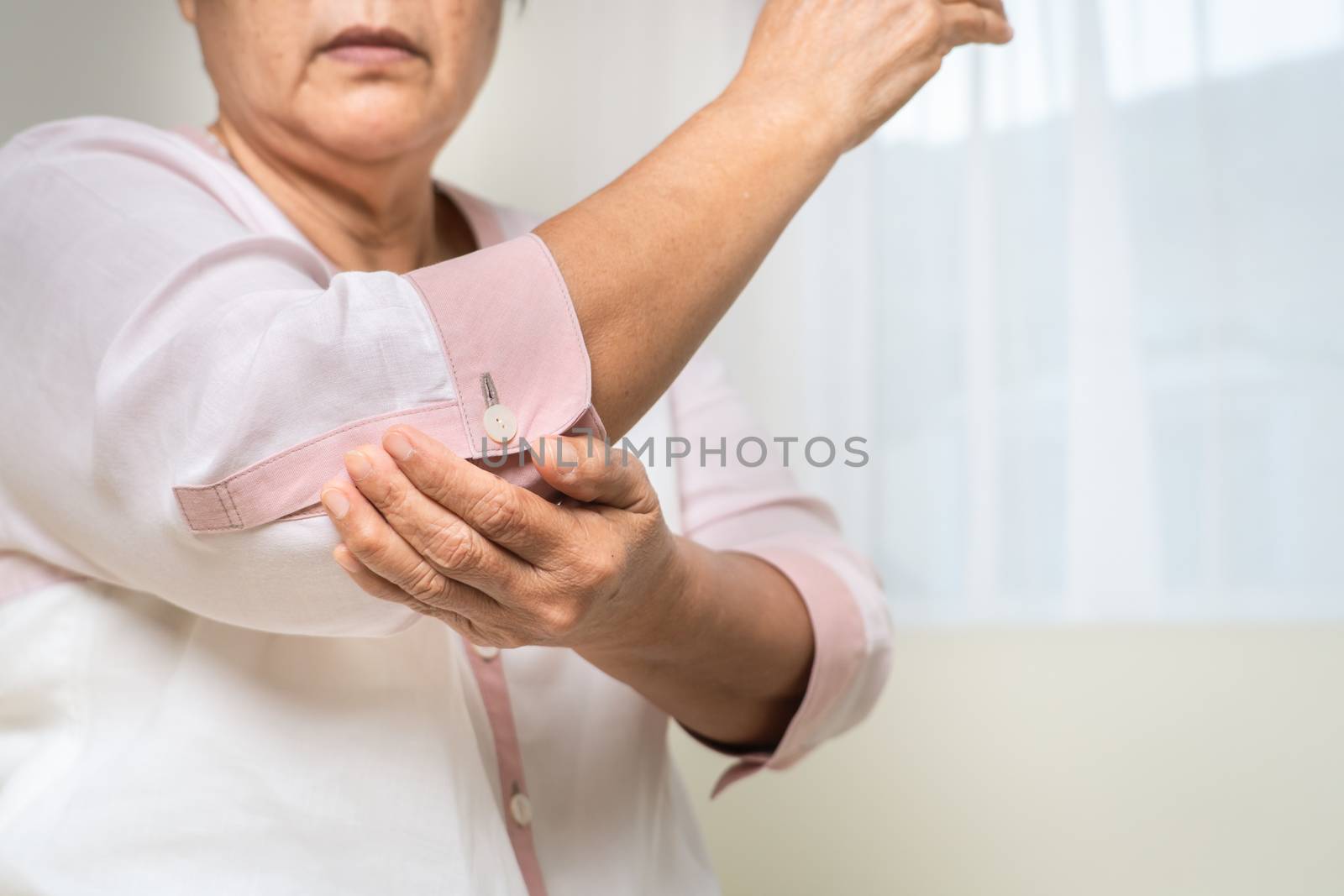 elbow pain old woman suffering from elbow pain at home, healthca by psodaz