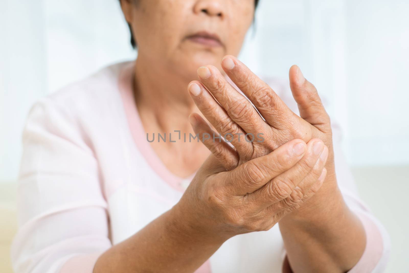 hand pain of old woman, healthcare problem of senior concept by psodaz