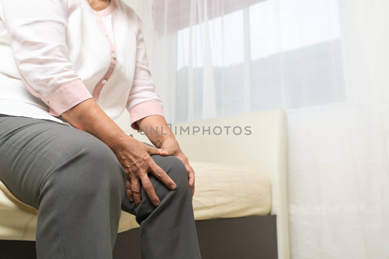 Knee pain of old woman at home, healthcare problem of senior con by psodaz