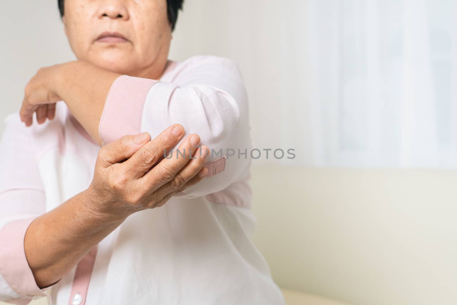 elbow pain old woman suffering from elbow pain at home, healthca by psodaz