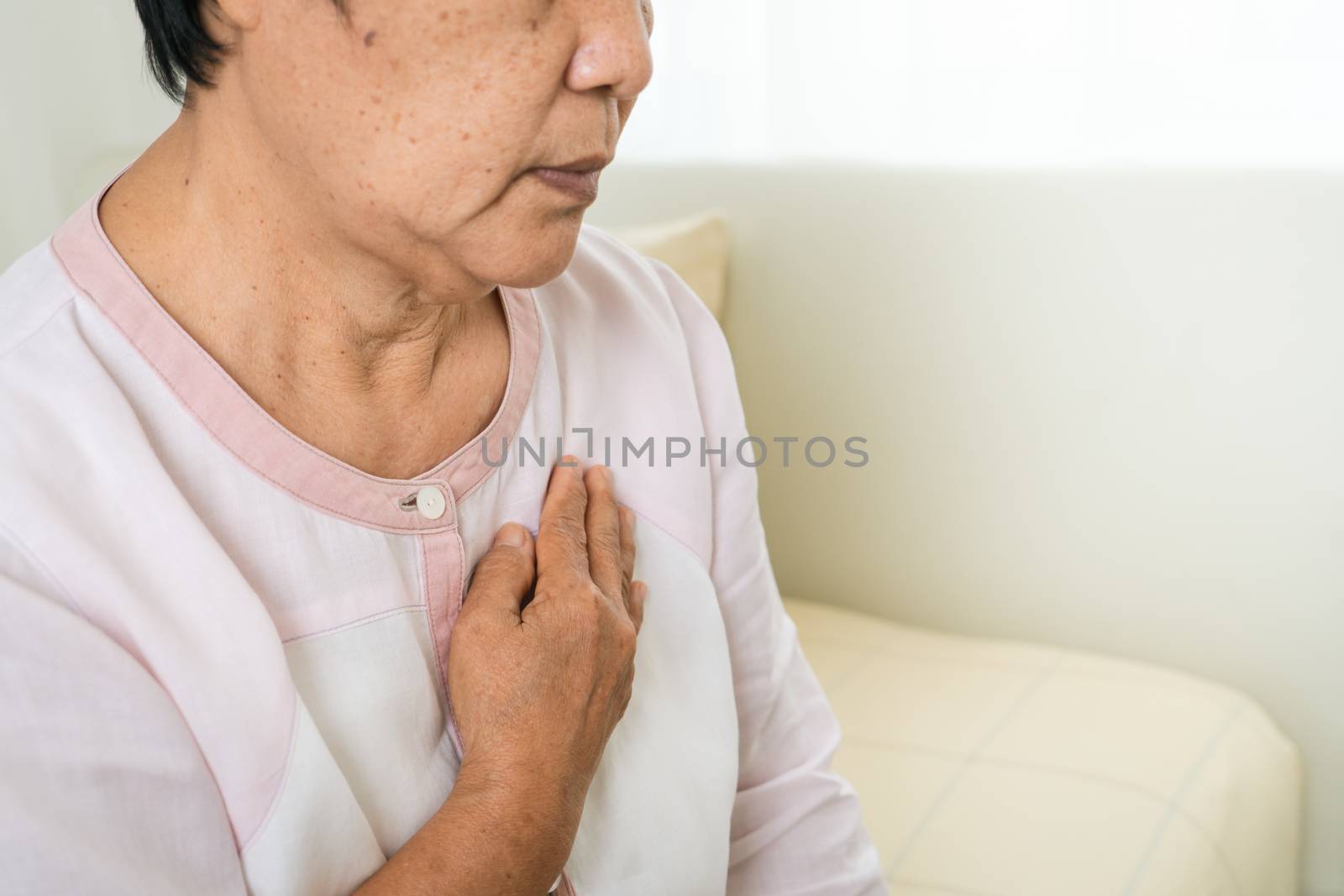 heart attack old woman holding chest in bed room, healthcare pro by psodaz