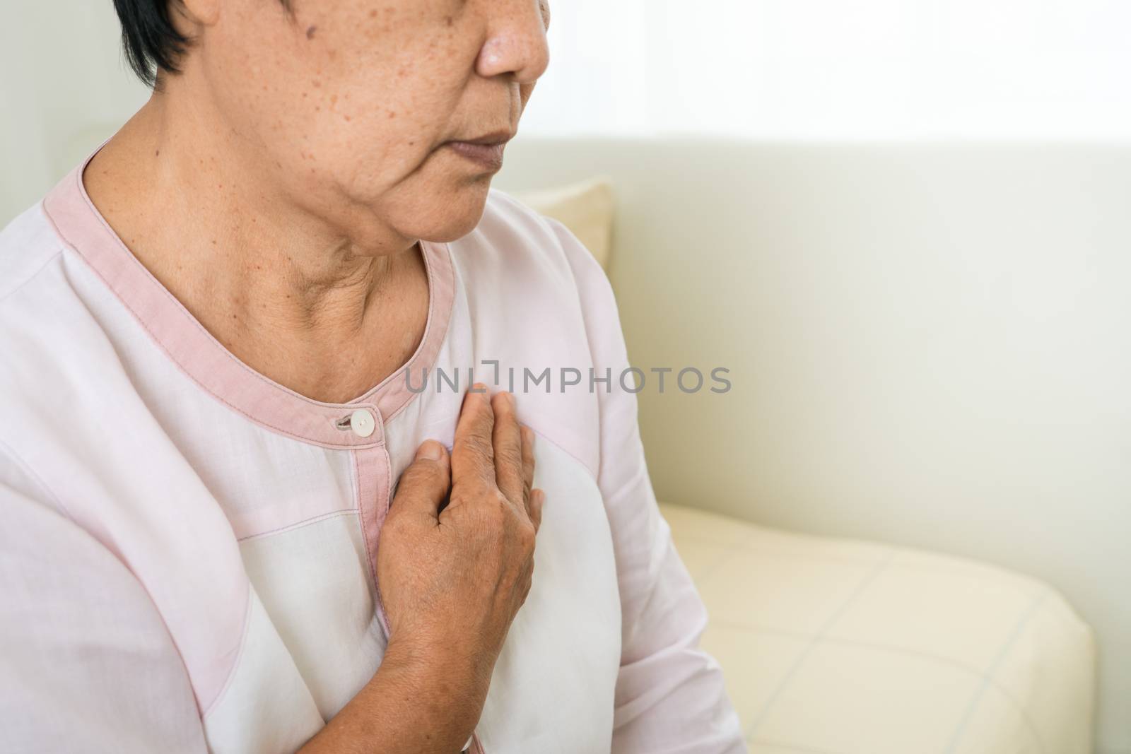 heart attack old woman holding chest in bed room, healthcare problem of senior concept