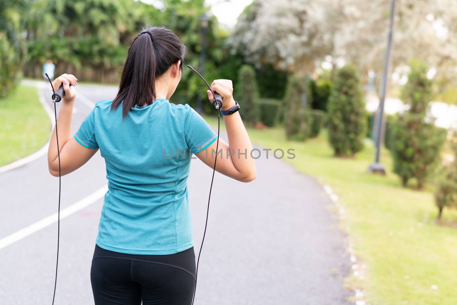 sports beginner woman doing exercises with jumping rope
