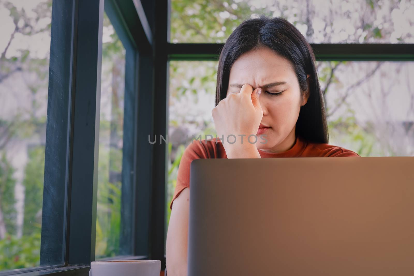 stressed businesswoman headache working on laptop computer. Nega by psodaz