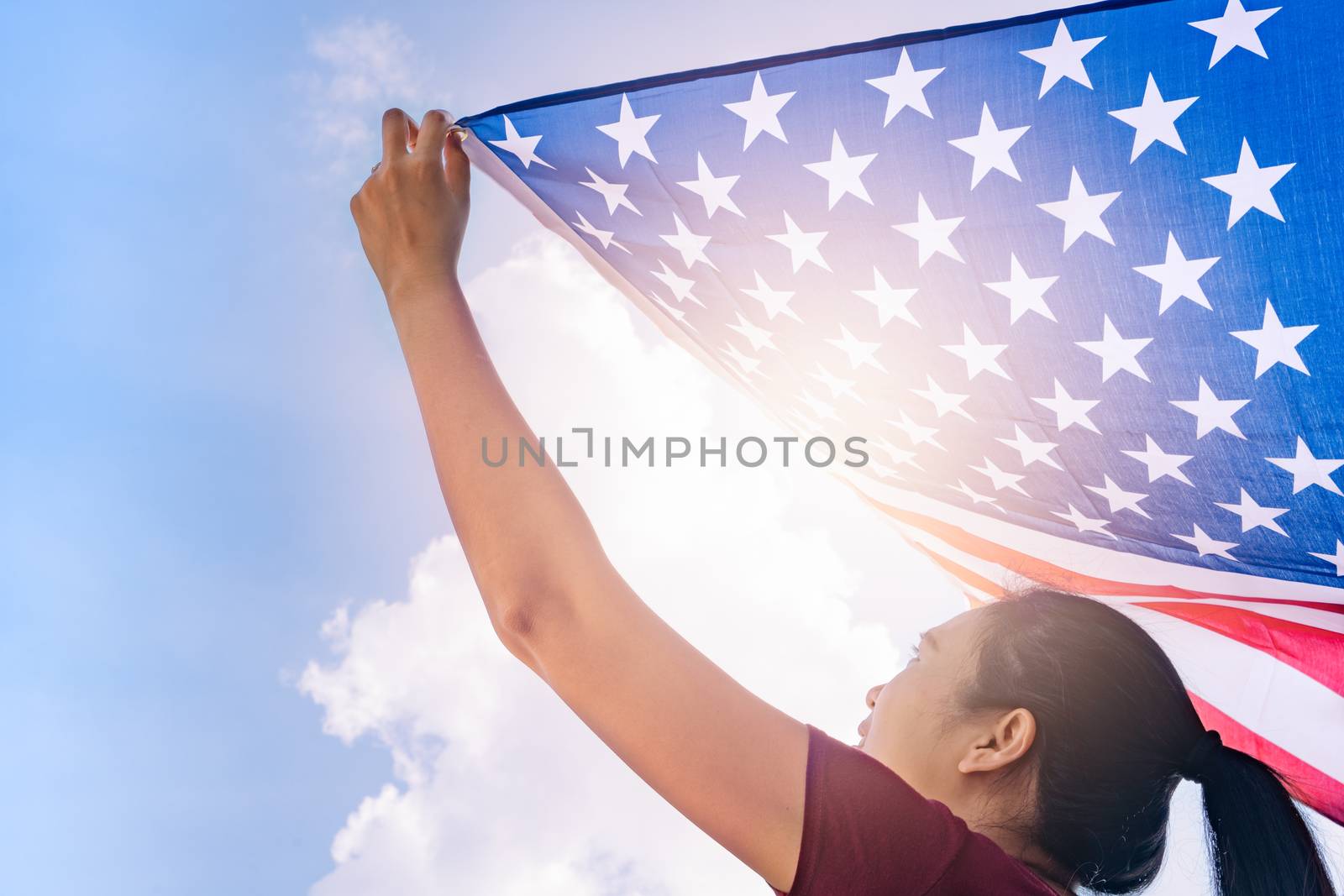 woman holding United States of America flag on sunny sky. USA Me by psodaz