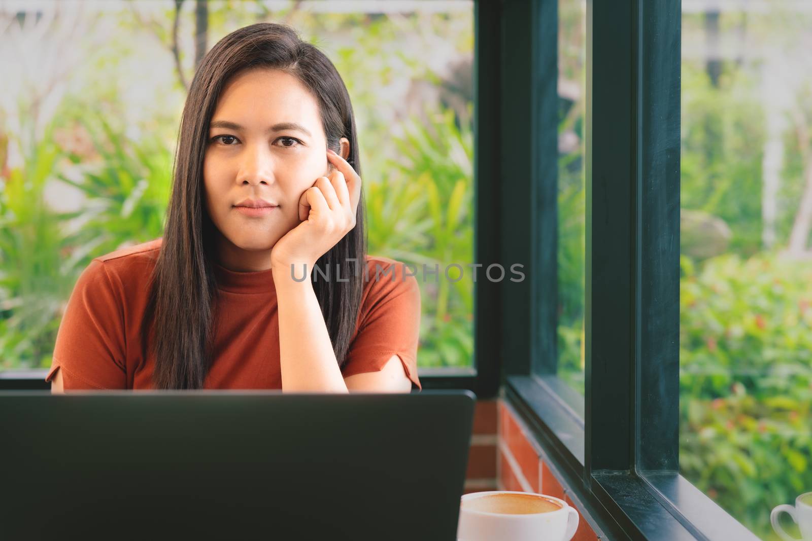 woman hands thinking while working on laptop look at camera. Woman working at office with coffee