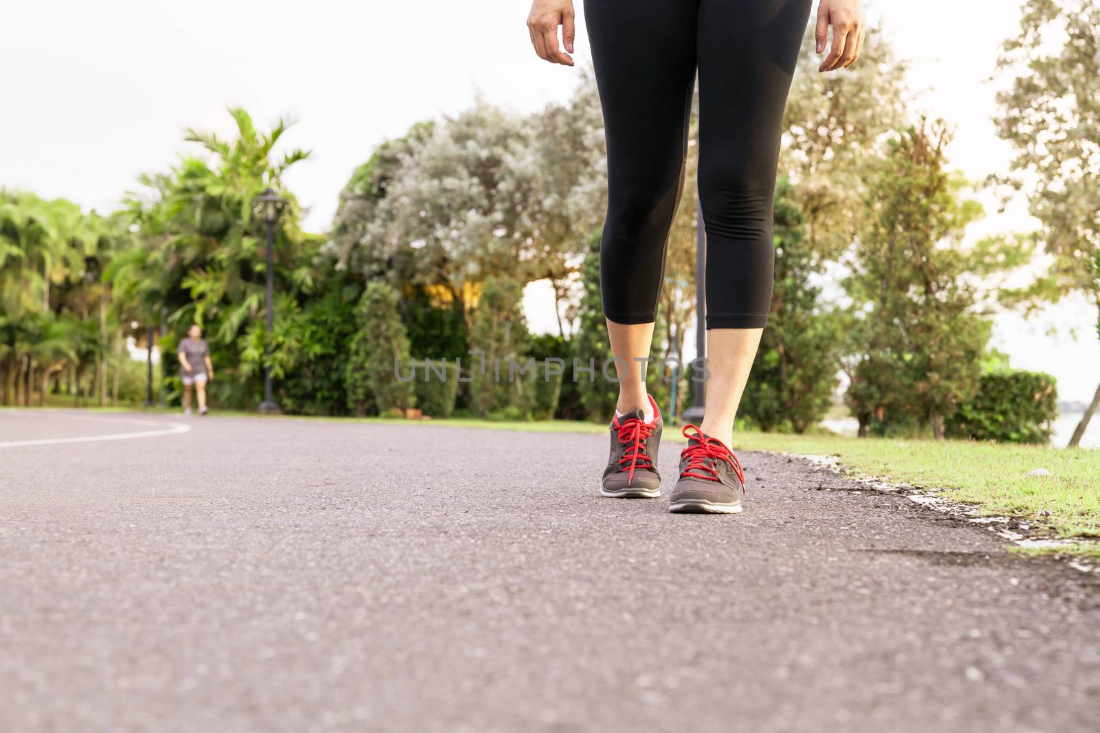 sport woman walking towards on the road side. Step concept by psodaz