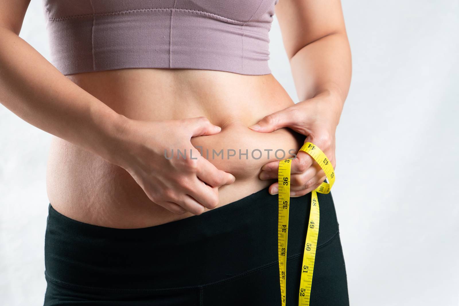 fat woman, fat belly, chubby, obese woman hand holding excessive belly fat with measure tape, woman diet lifestyle concept
