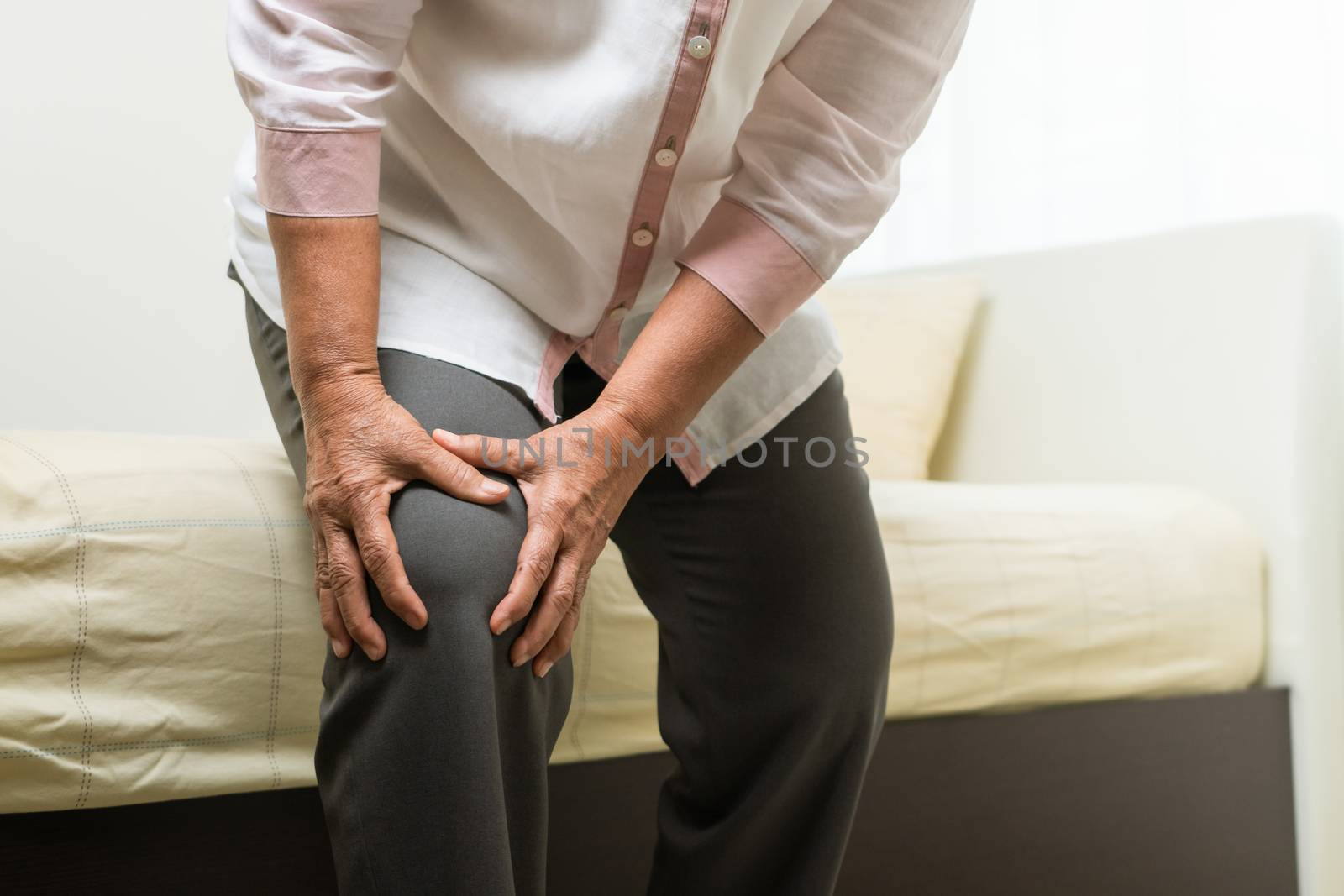 Knee pain of old woman at home, healthcare problem of senior con by psodaz