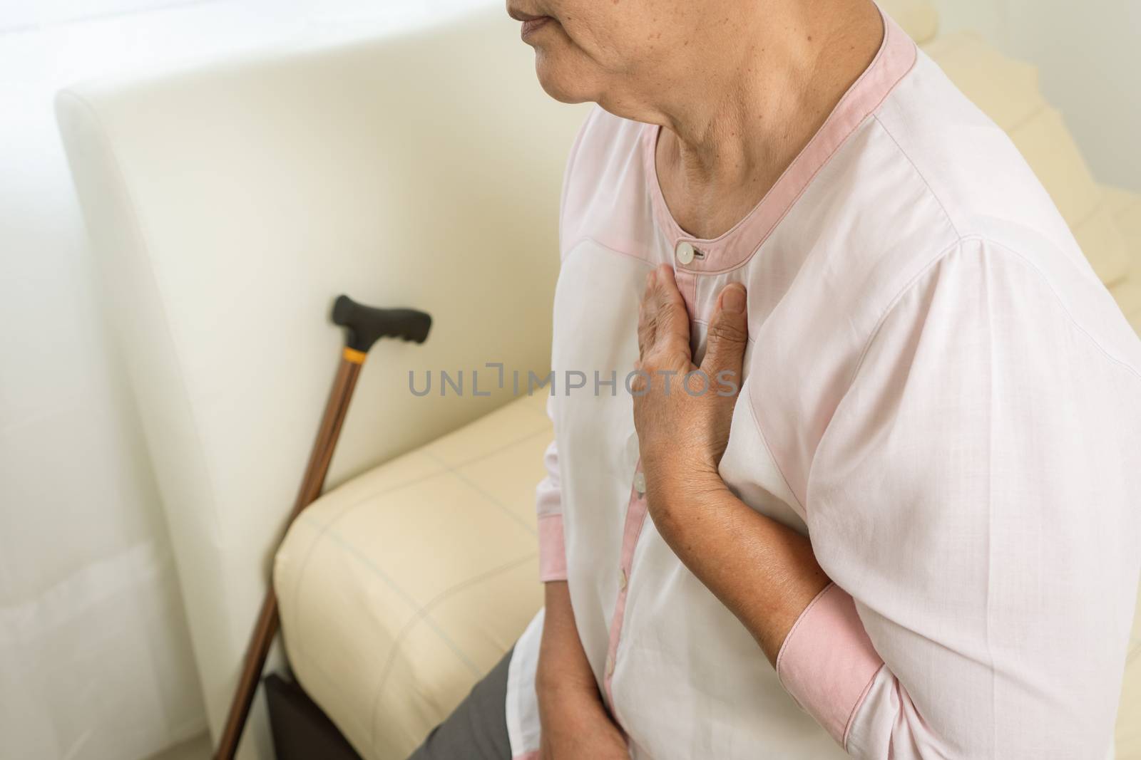 heart attack old woman holding chest in bed room, healthcare pro by psodaz