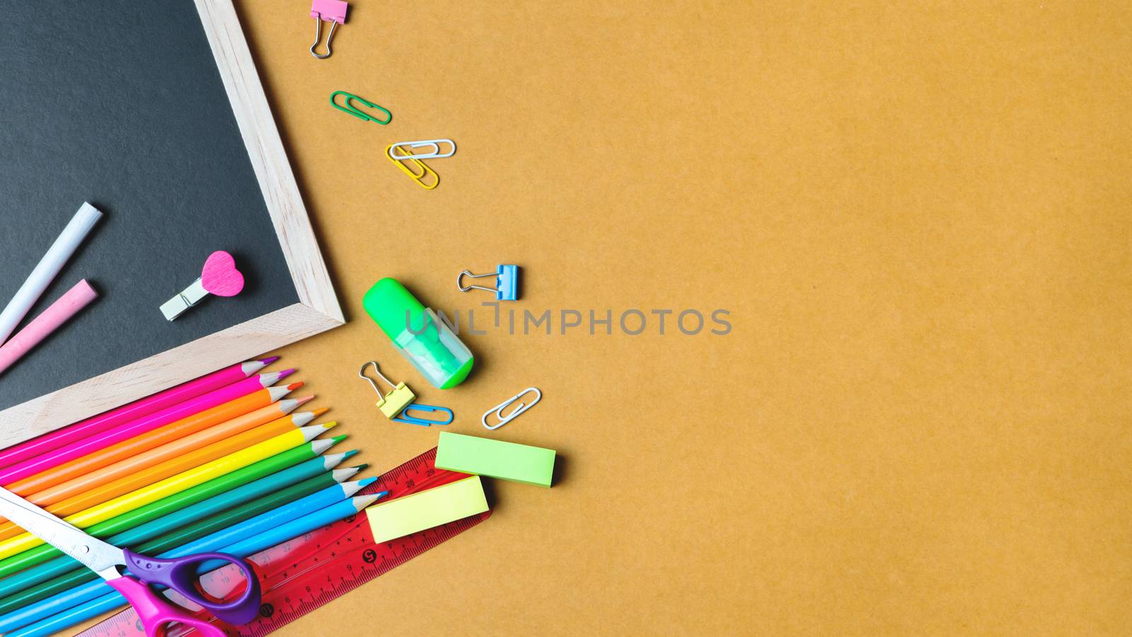 School supplies on black board background. Back to school concept