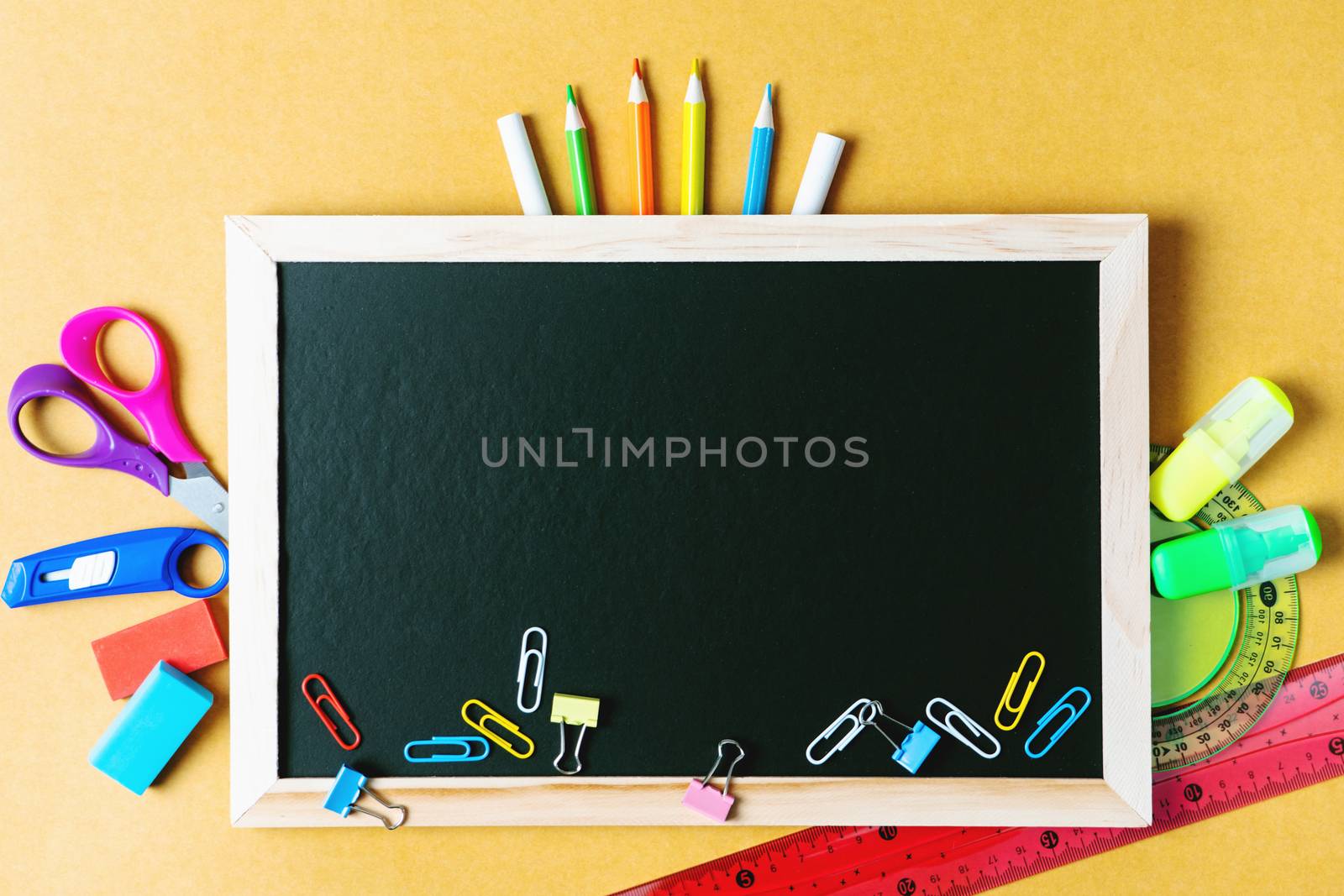 School supplies on black board background. Back to school concept