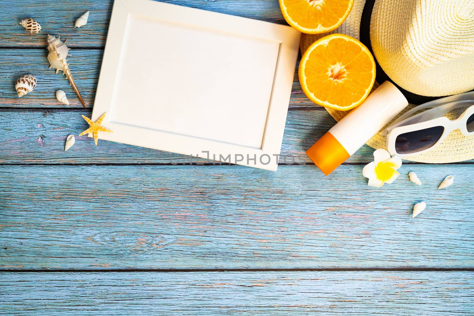 Beautiful summer holiday, Beach accessories, orange, sunglasses, hat and sunblock on wooden backgrounds