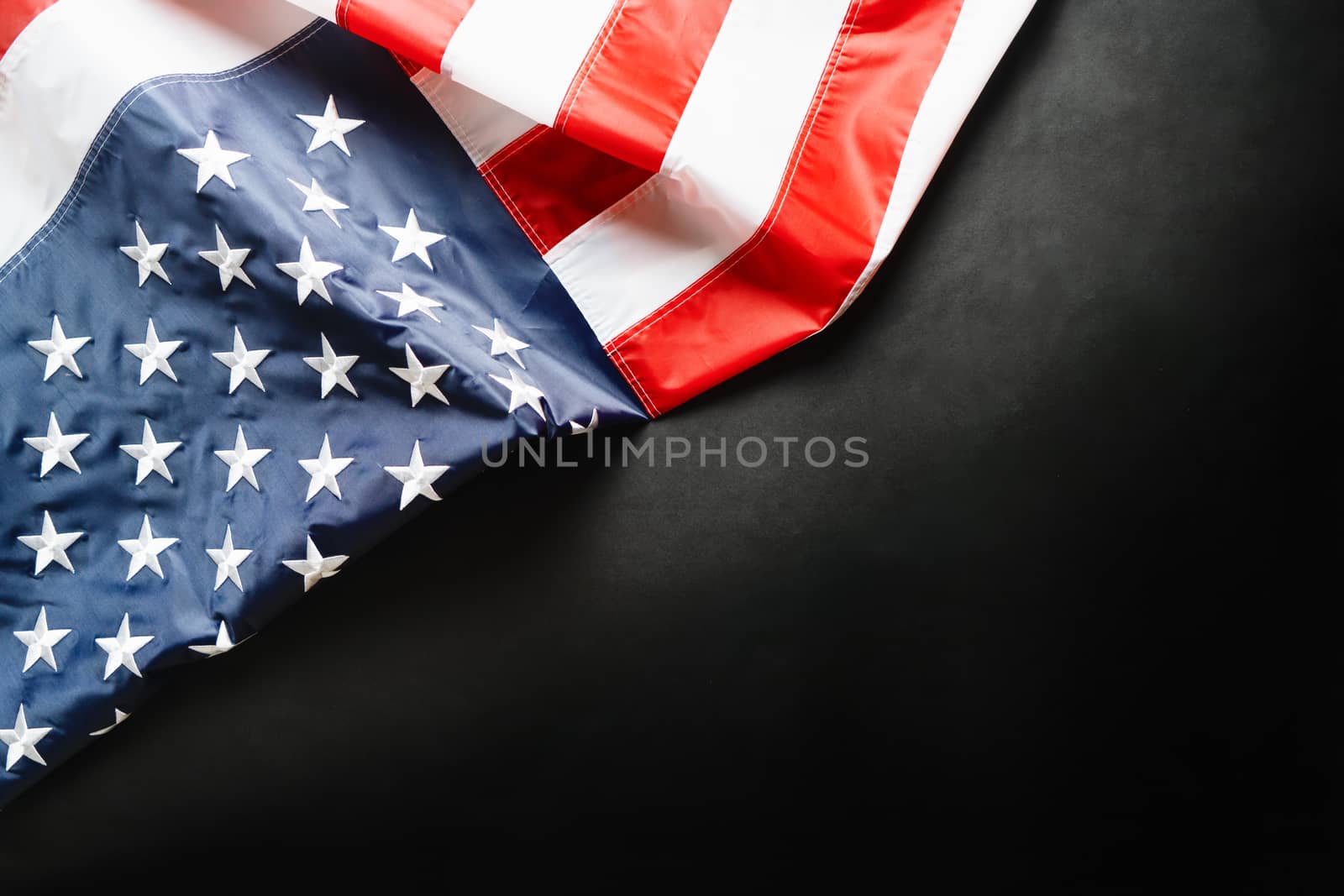 American flag on black background, stars and stripes closeup