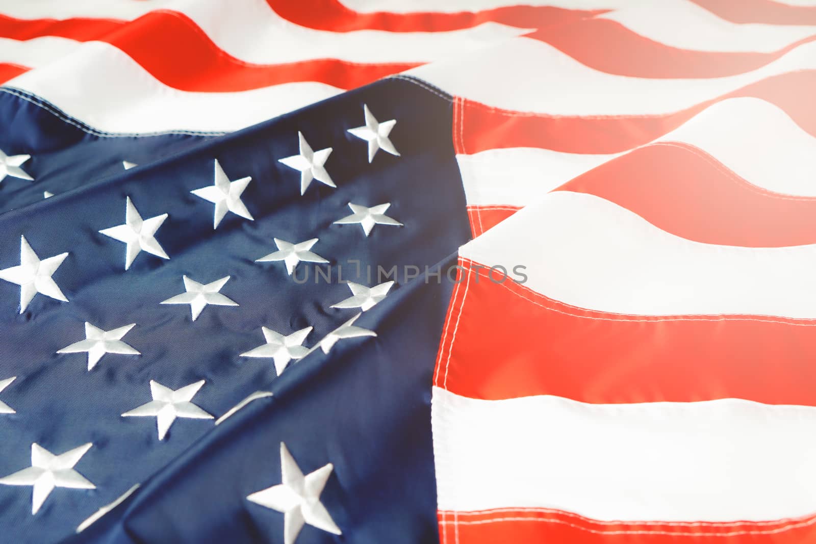 American flag waving in the wind, stars and stripes closeup by psodaz