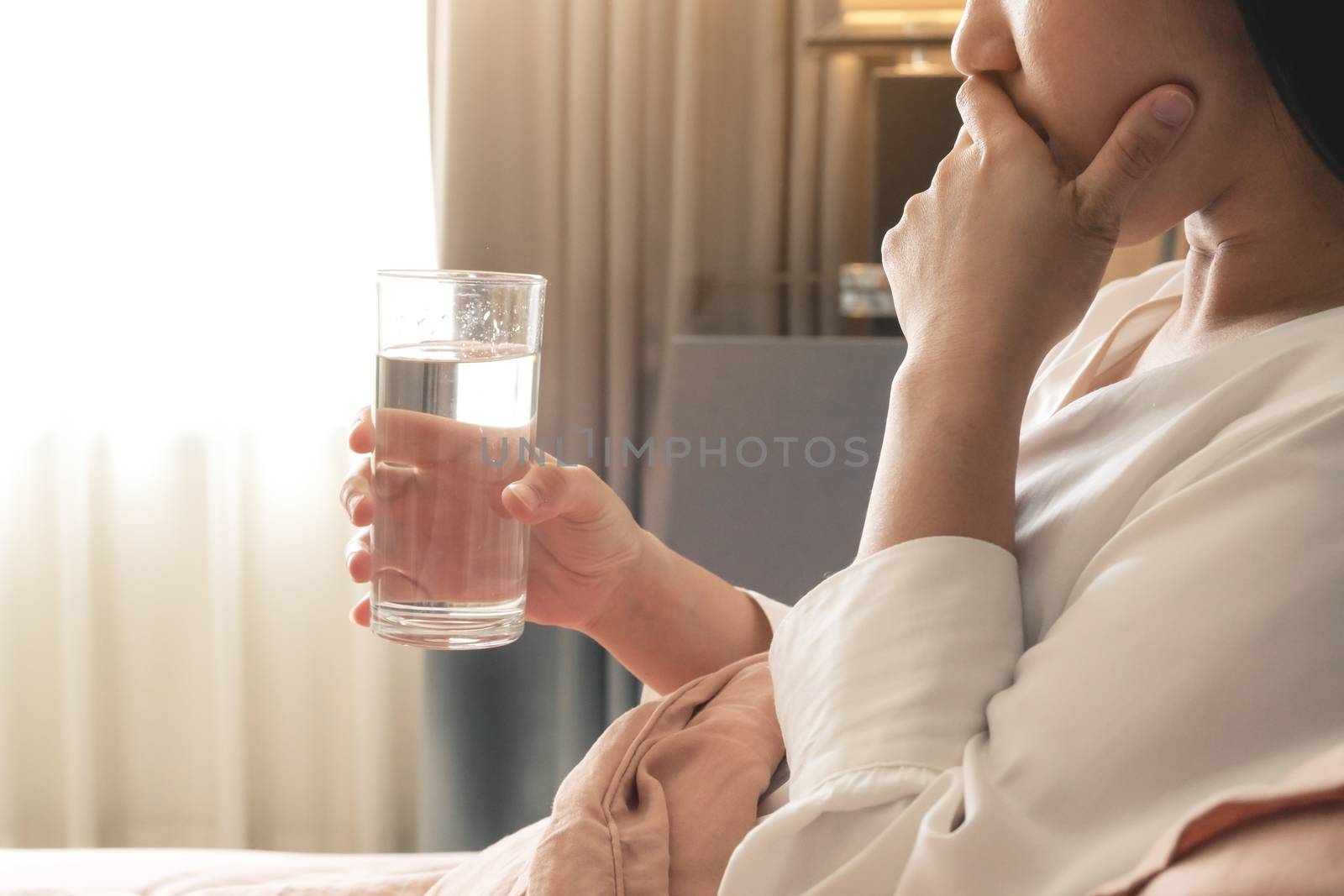 sick women hand hold a glass of water, healthcare and medicine r by psodaz