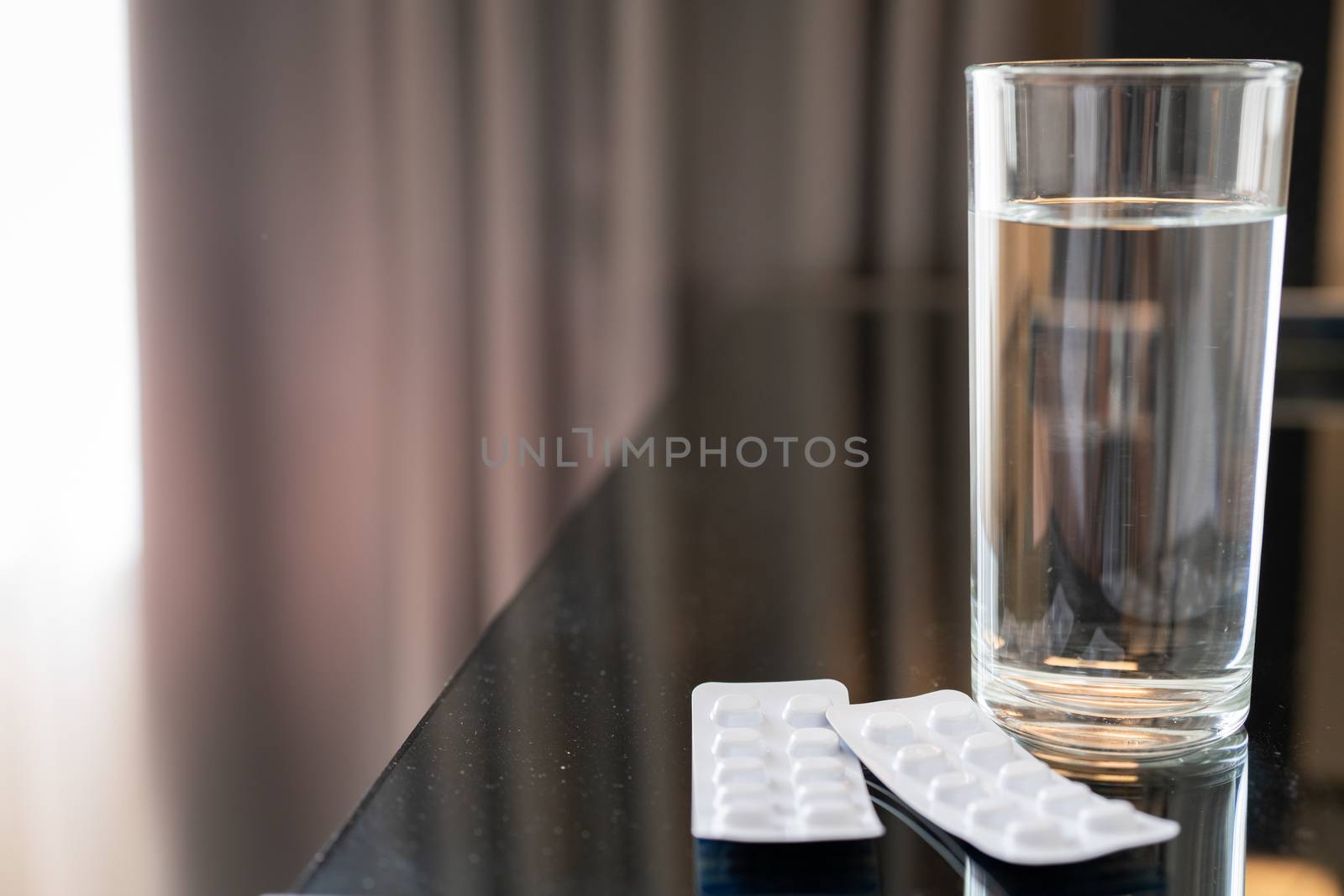 pills medicine tablets and glass of water, healthcare and medicine recovery concept