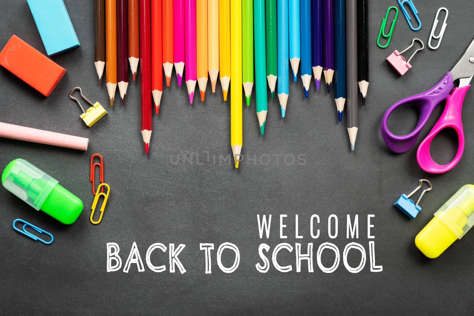 School supplies on black board background. Back to school concep by psodaz