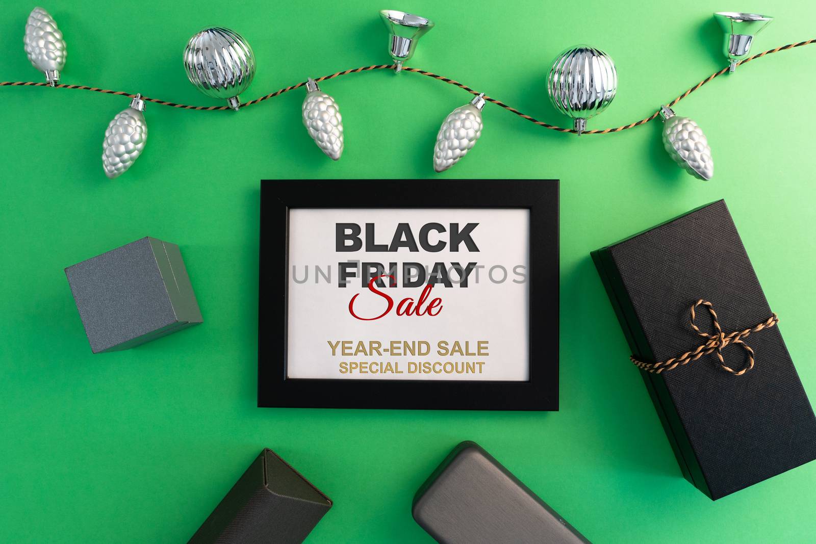 Black Friday Sale concept, gift box with photo frame on green background