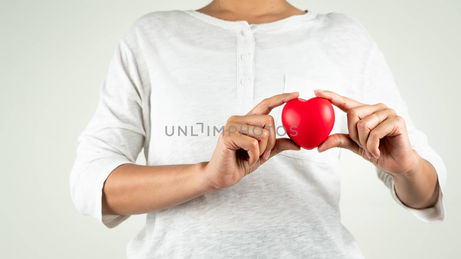 World heart day concept of young woman hand holding red heart