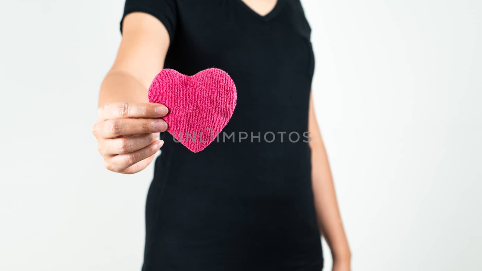 World heart day concept of young woman hand holding red heart