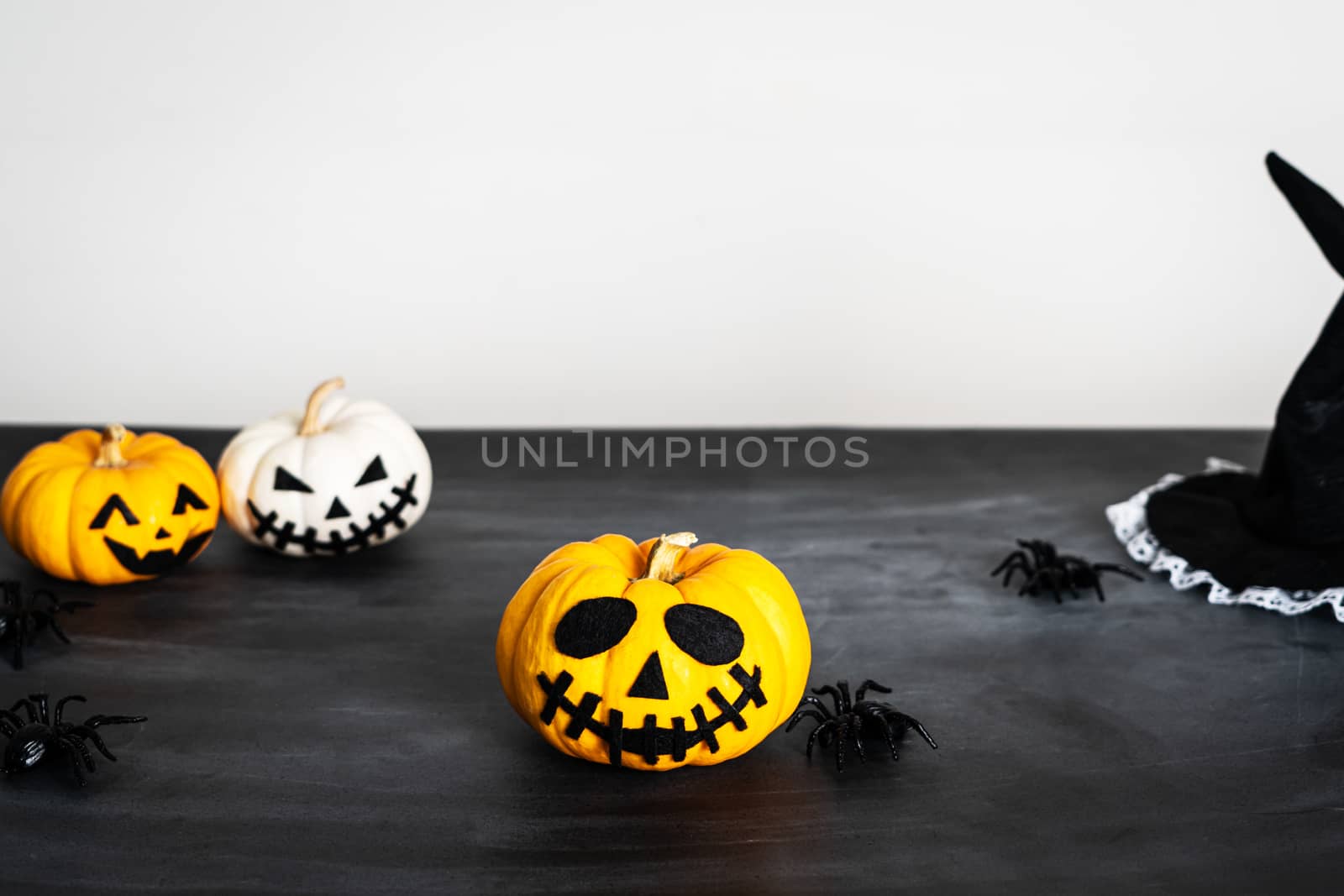 Happy Halloween, horror pumpkin and scary spider on black background