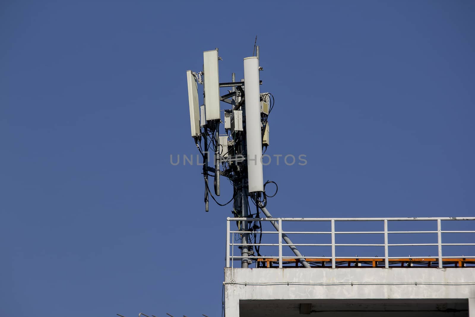Antenna on the rooftop of a residential building. Cellular mobile phone antenna