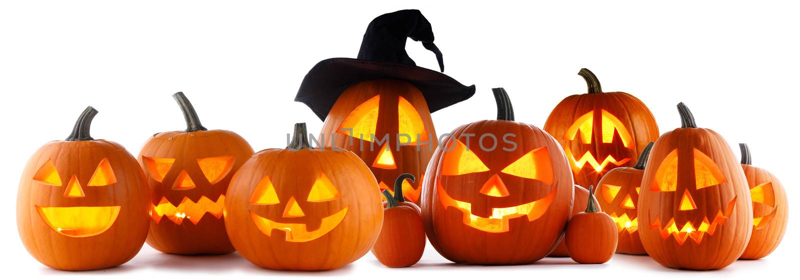 A collection of Jack O Lantern Halloween pumpkins with various different designs and witches hat in a row isolated on white background