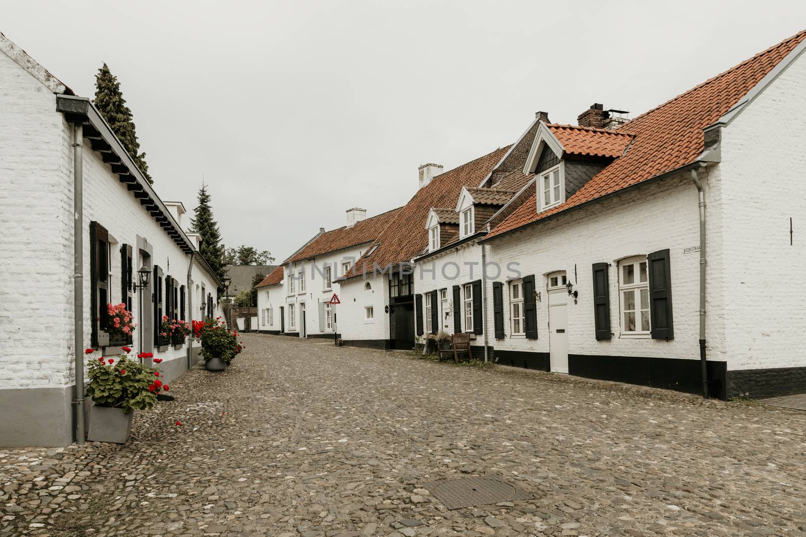 Street in the historic city of Thorn in Limburg, the Netherlands. Known for its white houses. also called the white city, it was painted white because of tax rules in the ancient times