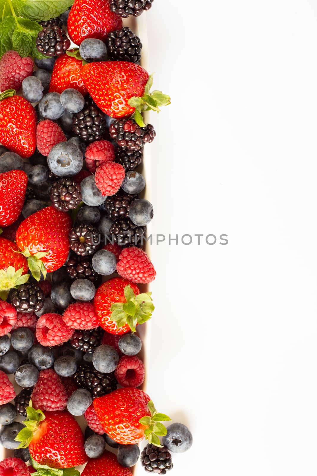 Strawberries, blackberries, rasberries, green mint on canvas white bakground. Mock up, menu, cafe poster concept