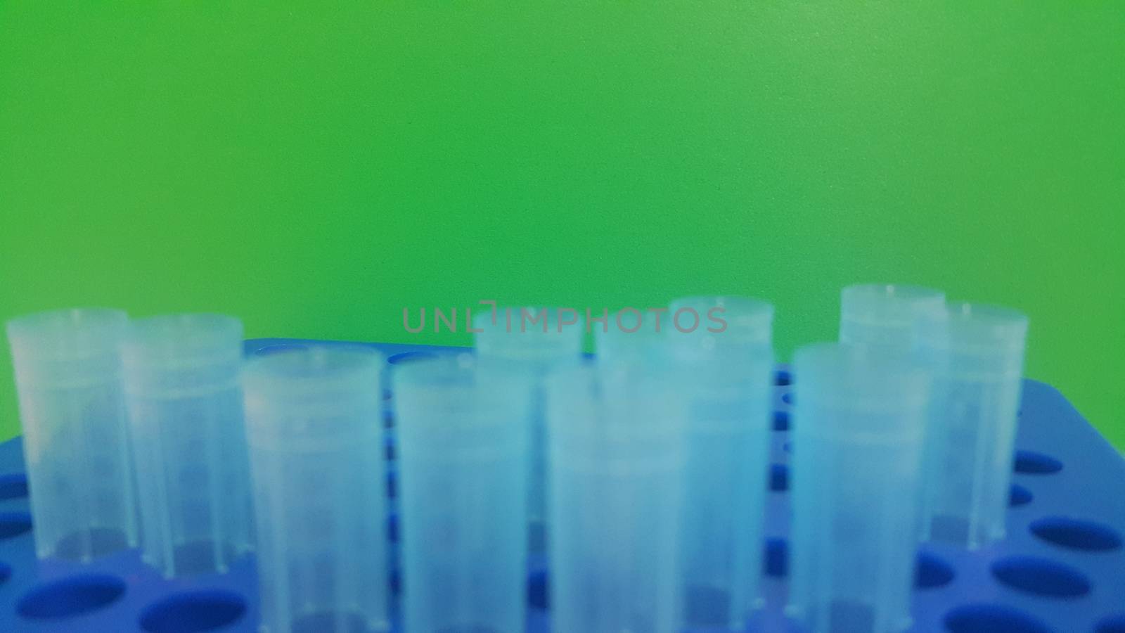 Close up view of blue micro litre tips in microtip box with empty holes. Reseach lab. tool for accurate measurement.