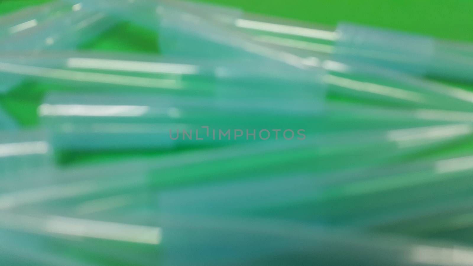 Close up view of micro litre tips on green floor sheet with empty holes. Reseach lab. tool for accurate measurement.