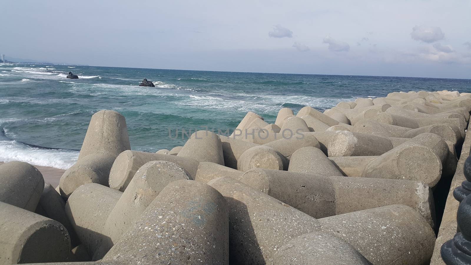 Close view of tetrapod stones on the sea shore to prevent coastal ersosion. Break water concrete tetrapods.