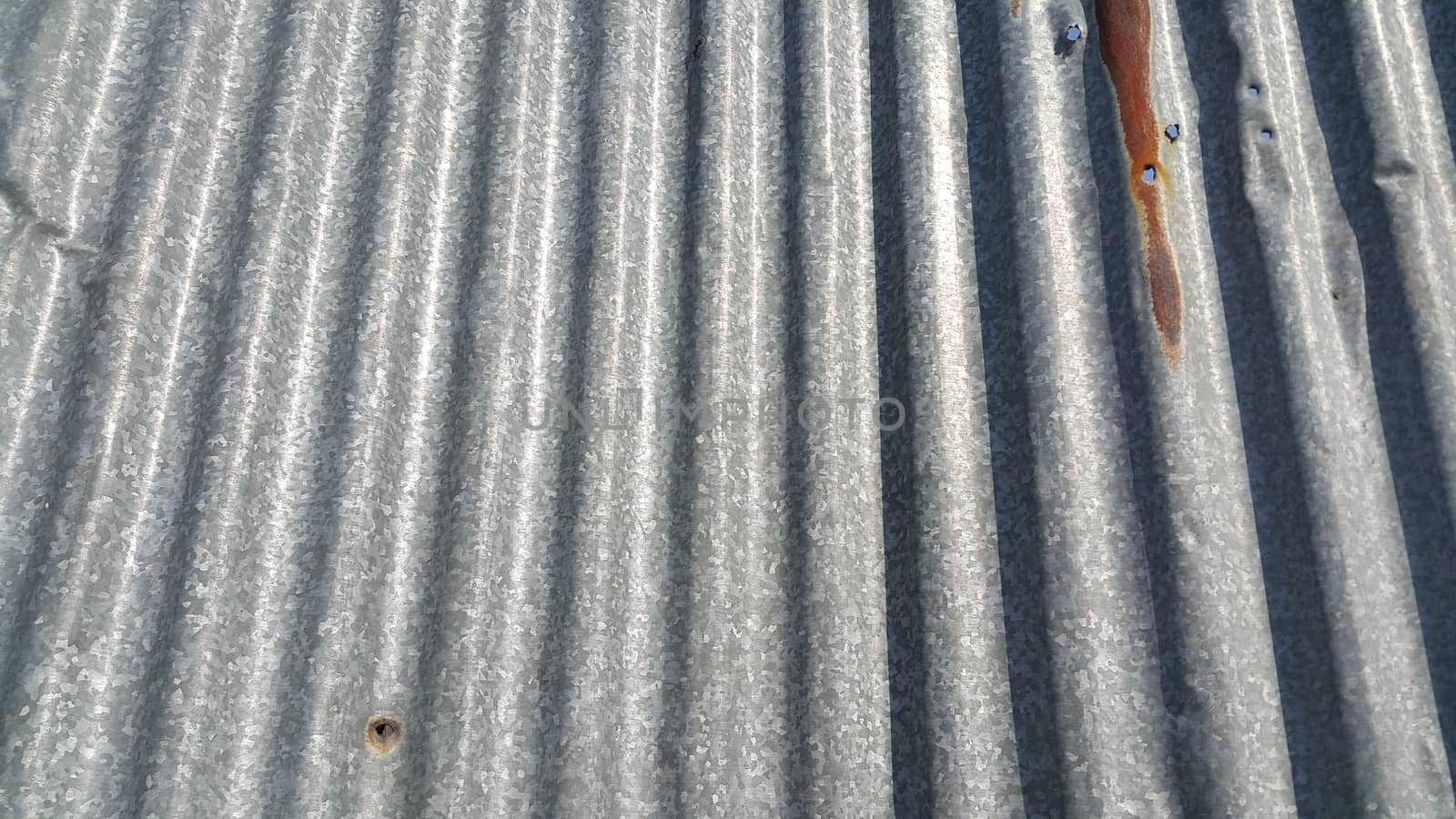 Silver corrugated metal sheet texture background. Steel metal cinc galvanized wave metal sheet for roof and walls.