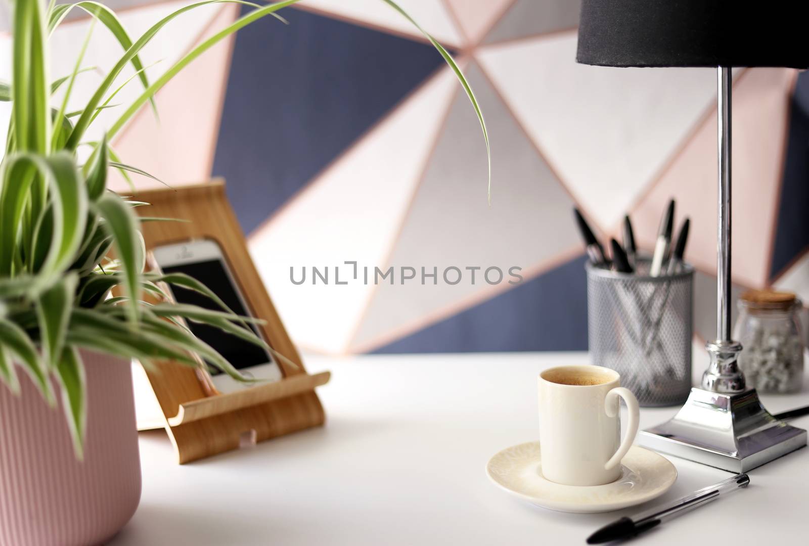Home office place with stationery, cup of coffee on multicolor background. Home office working station concept