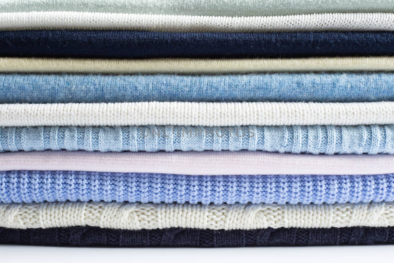 Pile of light pastel woolen clothes by NelliPolk