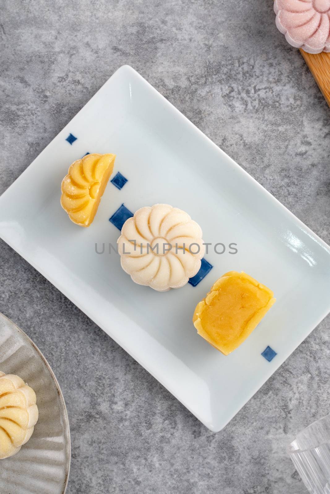 Colorful snow skin moon cake, sweet snowy mooncake, traditional savory dessert for Mid-Autumn Festival on gray cement background, top view