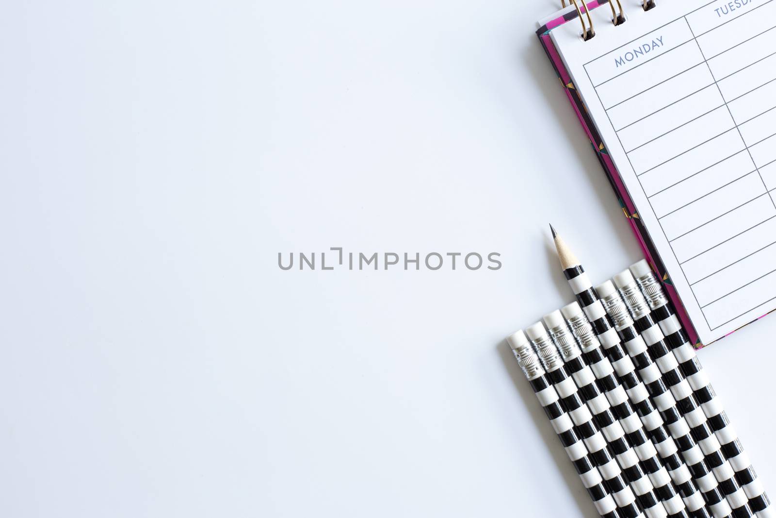 Weekly organizer planner, shaper and sharp pencil surrounded by dull pencils. Stationery flat lay. Back to school. White background. Business, sharp idear concept. Mock up